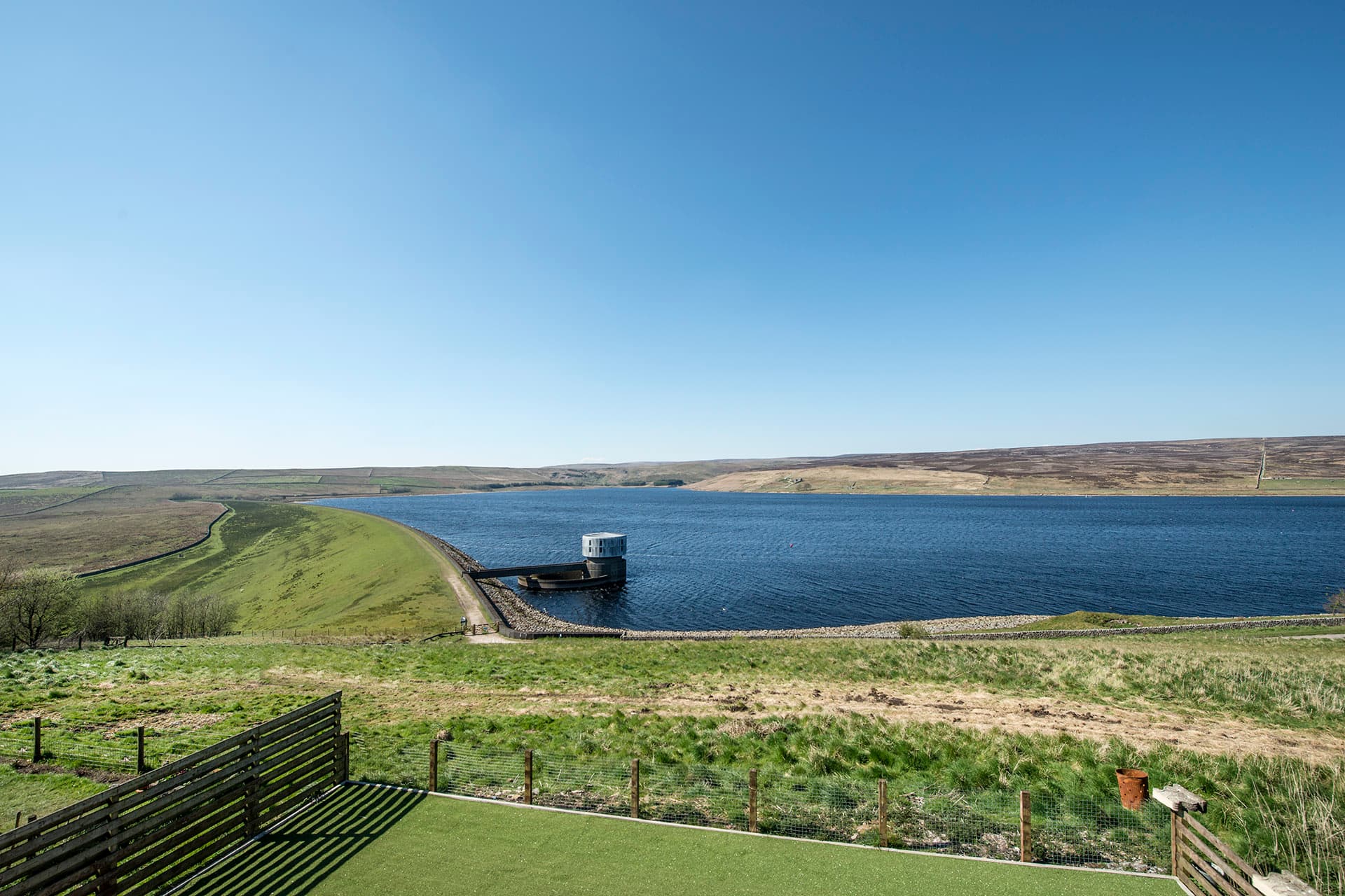 Bedroom window framing a view across Grimwith Reservoir
