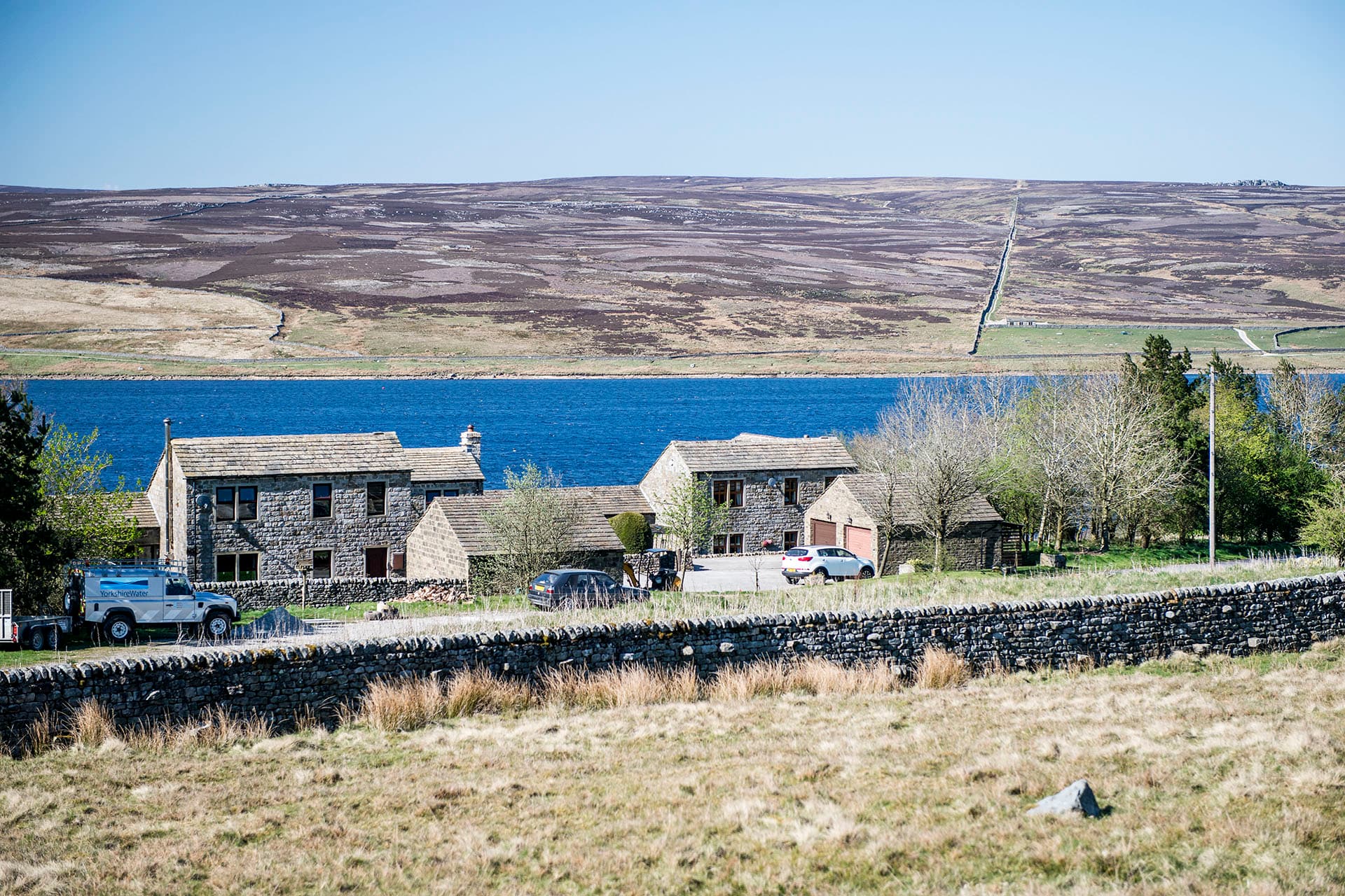 Grimwith House in its Dales hamlet setting above the reservoir